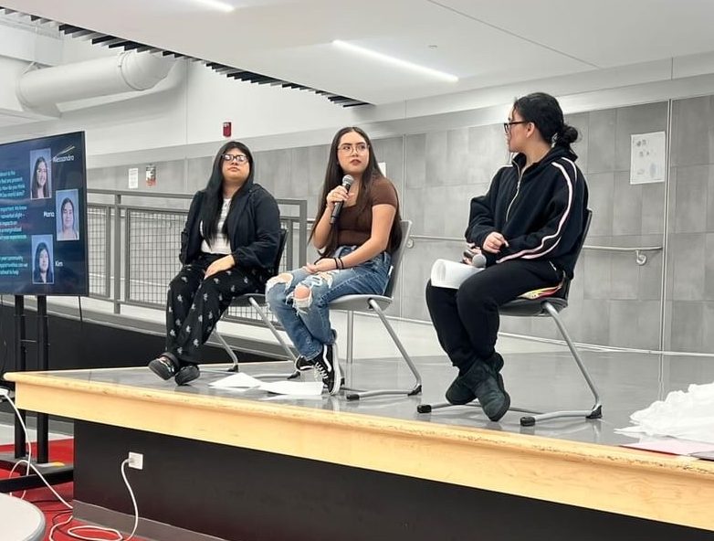 Alessandra Morales (middle) accompanied by Maria (right) and Kimberly Del Agua Mendoza (left) spoke in front of staff and teachers. 