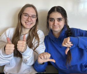 Enna Wold and Addy Florin, both seniors, disagree with how the tri is going. Wold (left) said, it's going great. I like all my classes and teachers." Florin (right) said "there's a lot of stressful assignments. Mostly just senior year in general is hard."