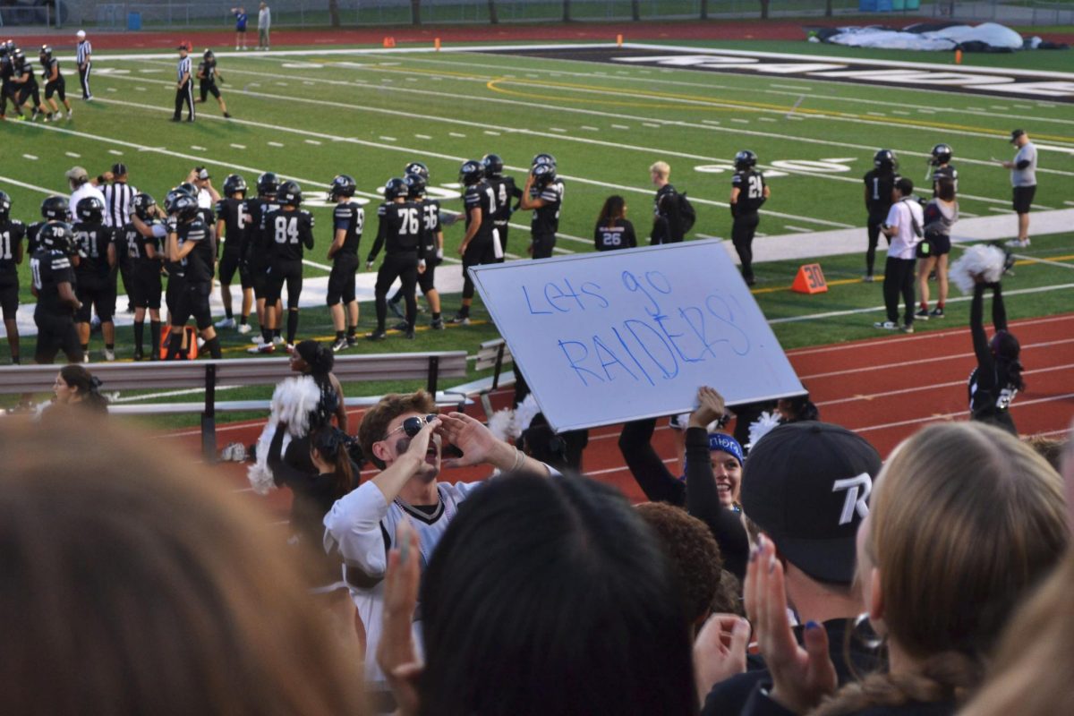 Crowd supports the Raider Football team
( Roseville homecoming game, Student section)